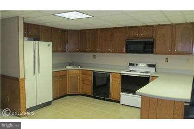 1006 Sturbridge Road, Unit 1006 Fallston, MD 21047 - Photo 6 of 11 a kitchen with a sink a stove and a refrigerator