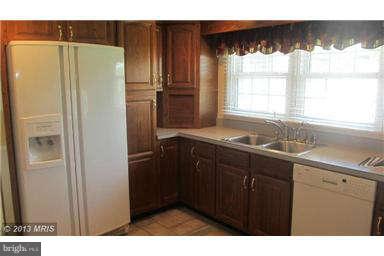 1006 Sturbridge Road, Unit 1006 Fallston, MD 21047 - Photo 8 of 11 a kitchen with stainless steel appliances granite countertop a refrigerator and a sink