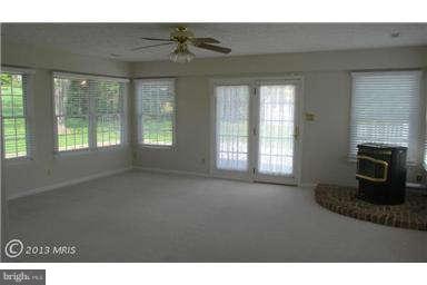 1006 Sturbridge Road, Unit 1006 Fallston, MD 21047 - Photo 9 of 11 a living room with furniture and a fireplace