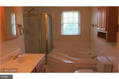 1006 Sturbridge Road, Unit 1006 Fallston, MD 21047 - Photo 10 of 11 a bathroom with a tub sink and mirror