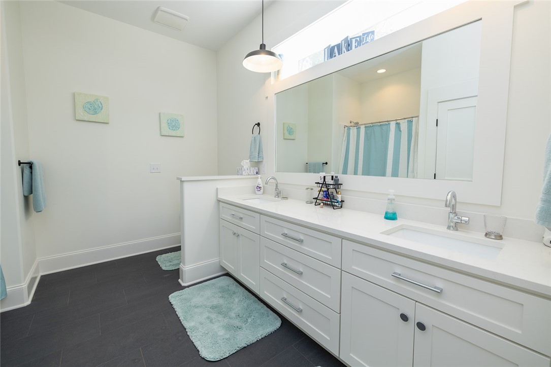 516 Pointe W Drive Seneca, SC 29672 - Photo 34 of 47 An ensuite bath includes a double-sink vanity, tub