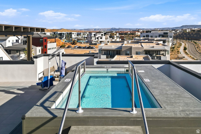 961 West Akoya Pearl Road, Unit 300 St. George, UT 84790 - Photo 49 of 60 Community pool featuring a patio area, a mountain view, and a residential view