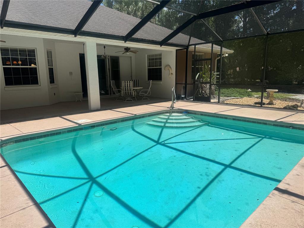 11145 Northwest 17th Court Road Ocala, FL 34475 - Photo 48 of 59 a swimming pool with yard outdoor seating and yard