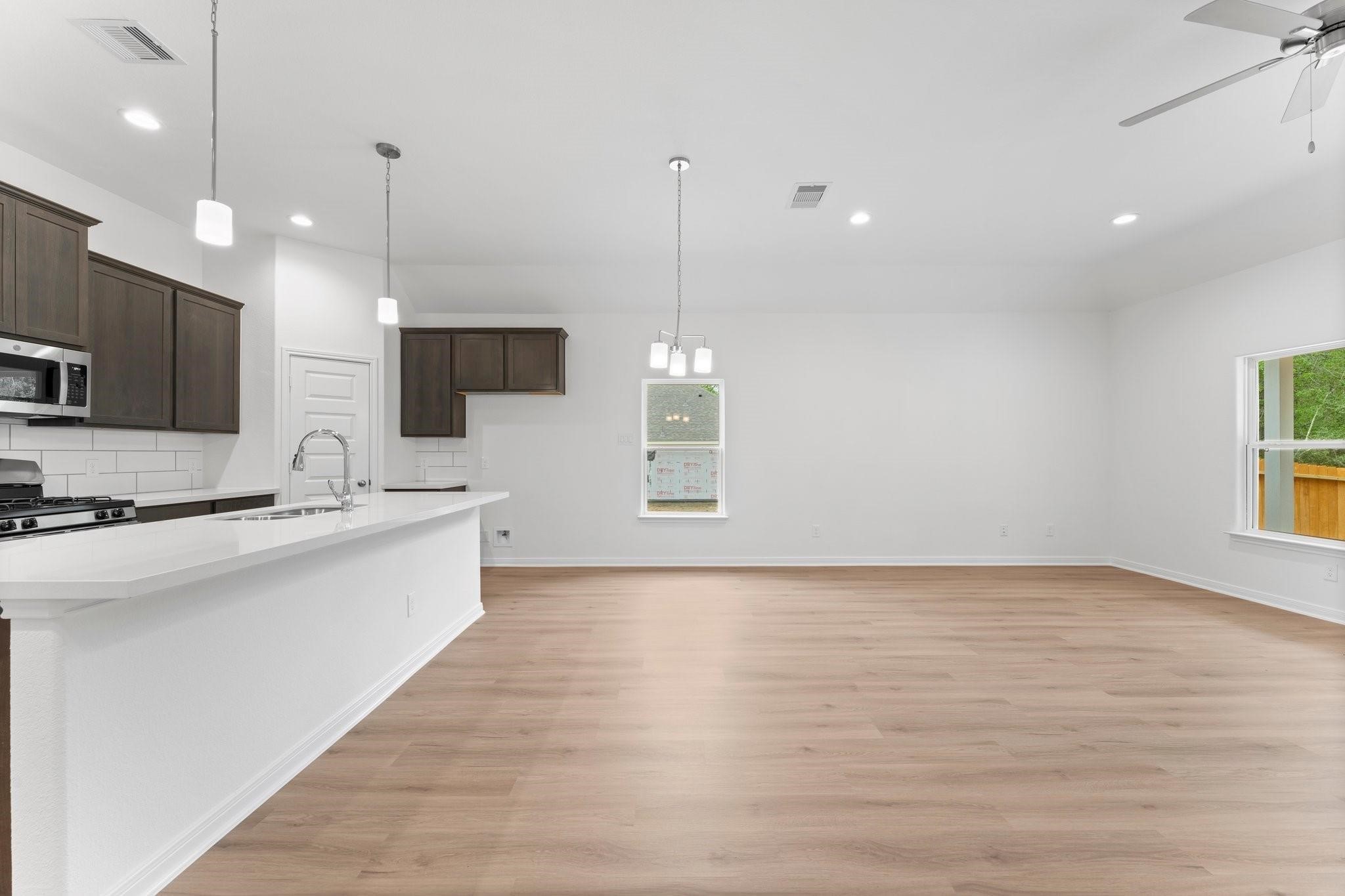 12011 Noble Heart Drive Willis, TX 77318 - Photo 20 of 35 a large kitchen with kitchen island a sink stainless steel appliances and a chandelier