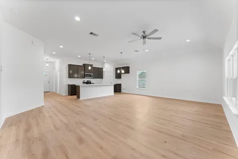 a view of a kitchen with a dishwasher and a stove top oven