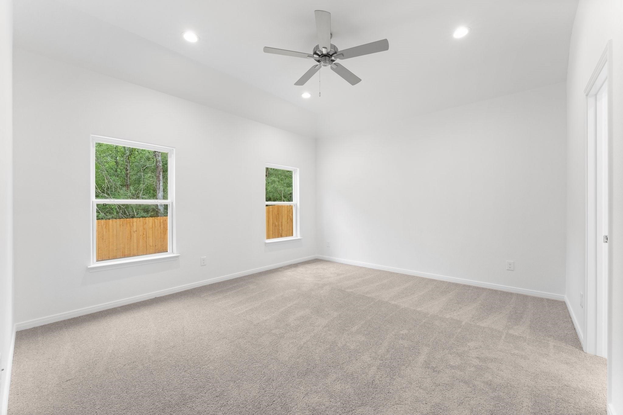 12011 Noble Heart Drive Willis, TX 77318 - Photo 23 of 35 an empty room with a window and a ceiling fan
