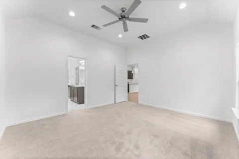 an empty room with closet and windows