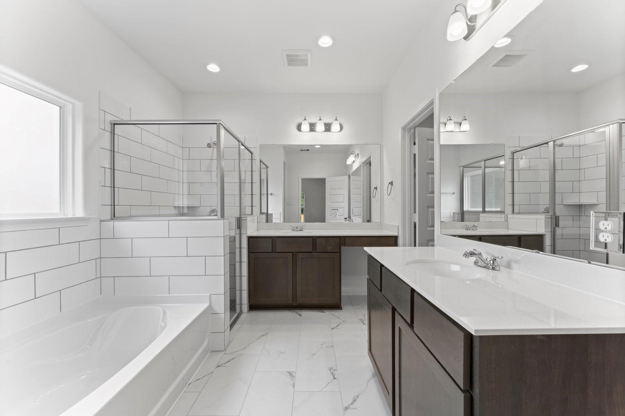 12011 Noble Heart Drive Willis, TX 77318 - Photo 26 of 35 a bathroom with a tub a sink shower and mirror