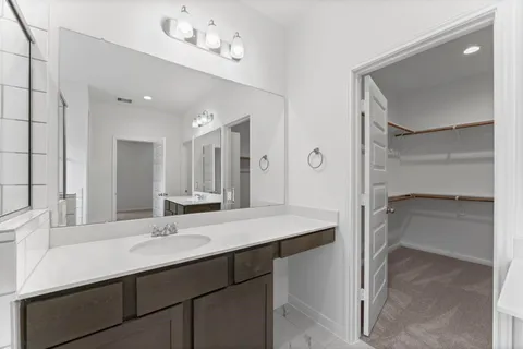 a bathroom with a sink double vanity and a mirror
