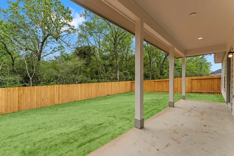a view of a backyard with large trees and a small yard