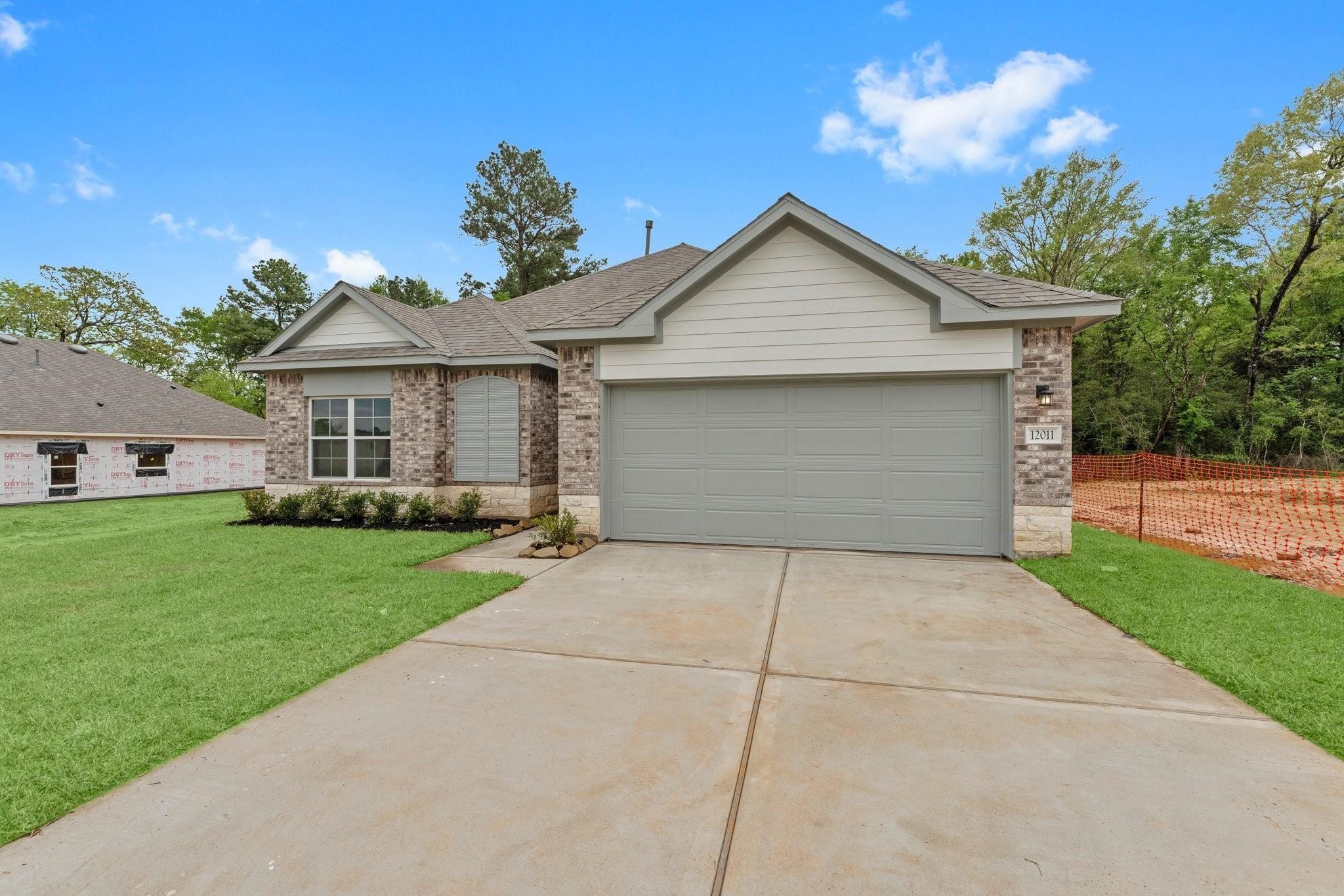 12011 Noble Heart Drive Willis, TX 77318 - Photo 4 of 35 a front view of house with yard and green space