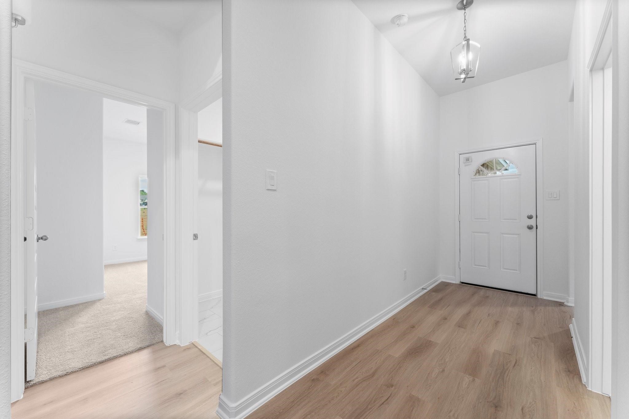12011 Noble Heart Drive Willis, TX 77318 - Photo 7 of 35 a view of a hallway with wooden floor and a hallway