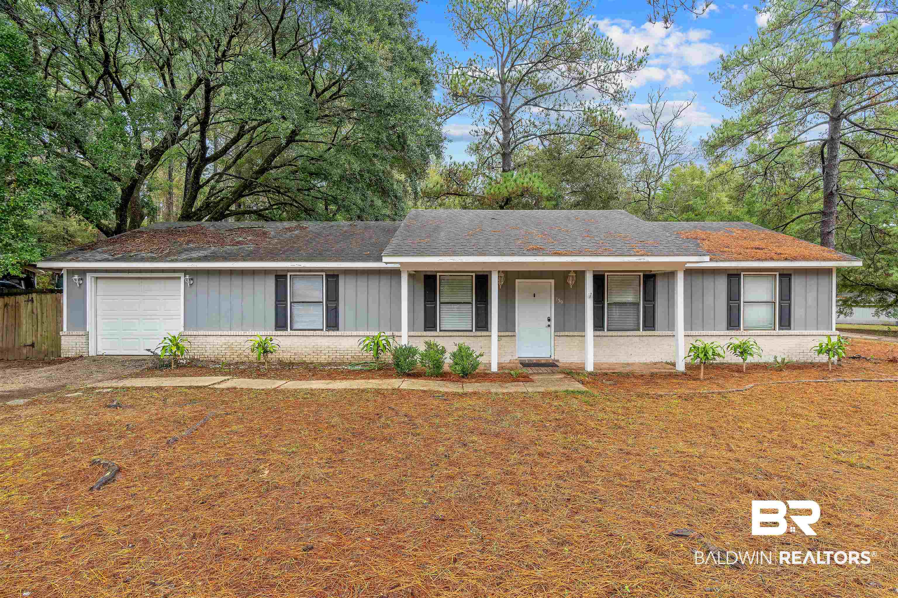 159 Montclair Loop Daphne, AL 36526 - Photo 18 of 18 Ranch-style home with brick siding, covered porch, roof with shingles, board and batten siding, and a garage