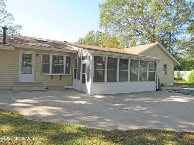 a view of a house with a yard and potted plants