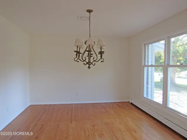 a view of a room has window and wooden floor