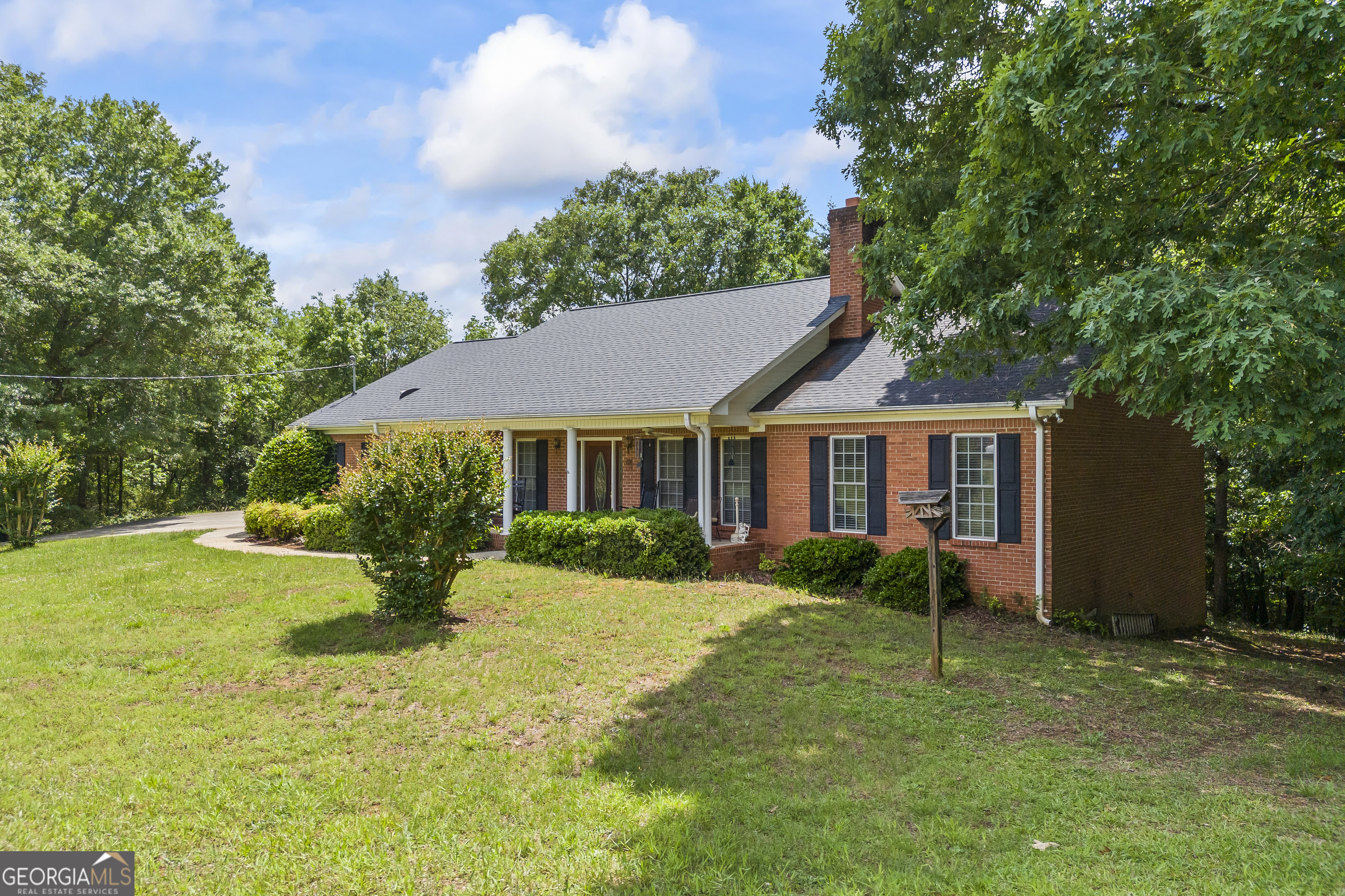 1112 Reno Road Royston, GA 30662 - Photo 11 of 74 a view of a house with a yard and potted plants