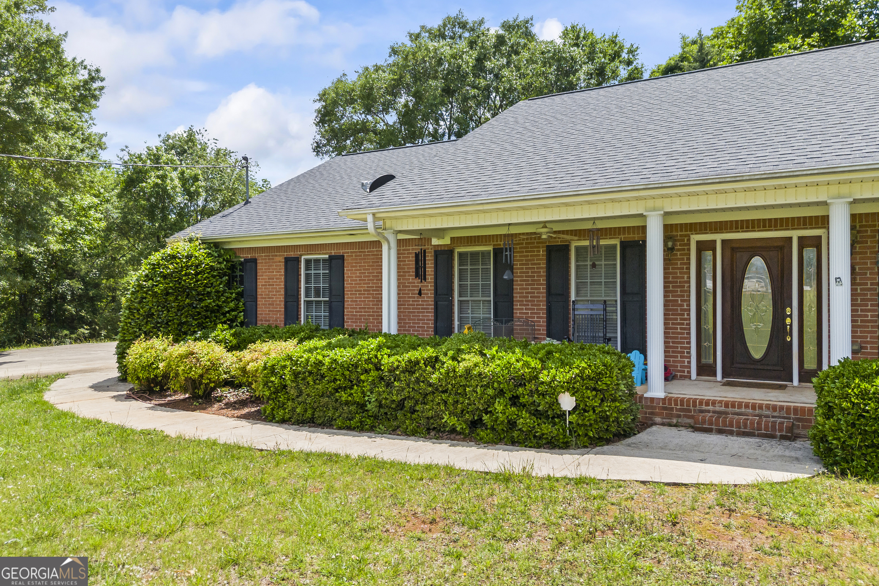 1112 Reno Road Royston, GA 30662 - Photo 13 of 74 a view of a house with potted plants and a table and chairs
