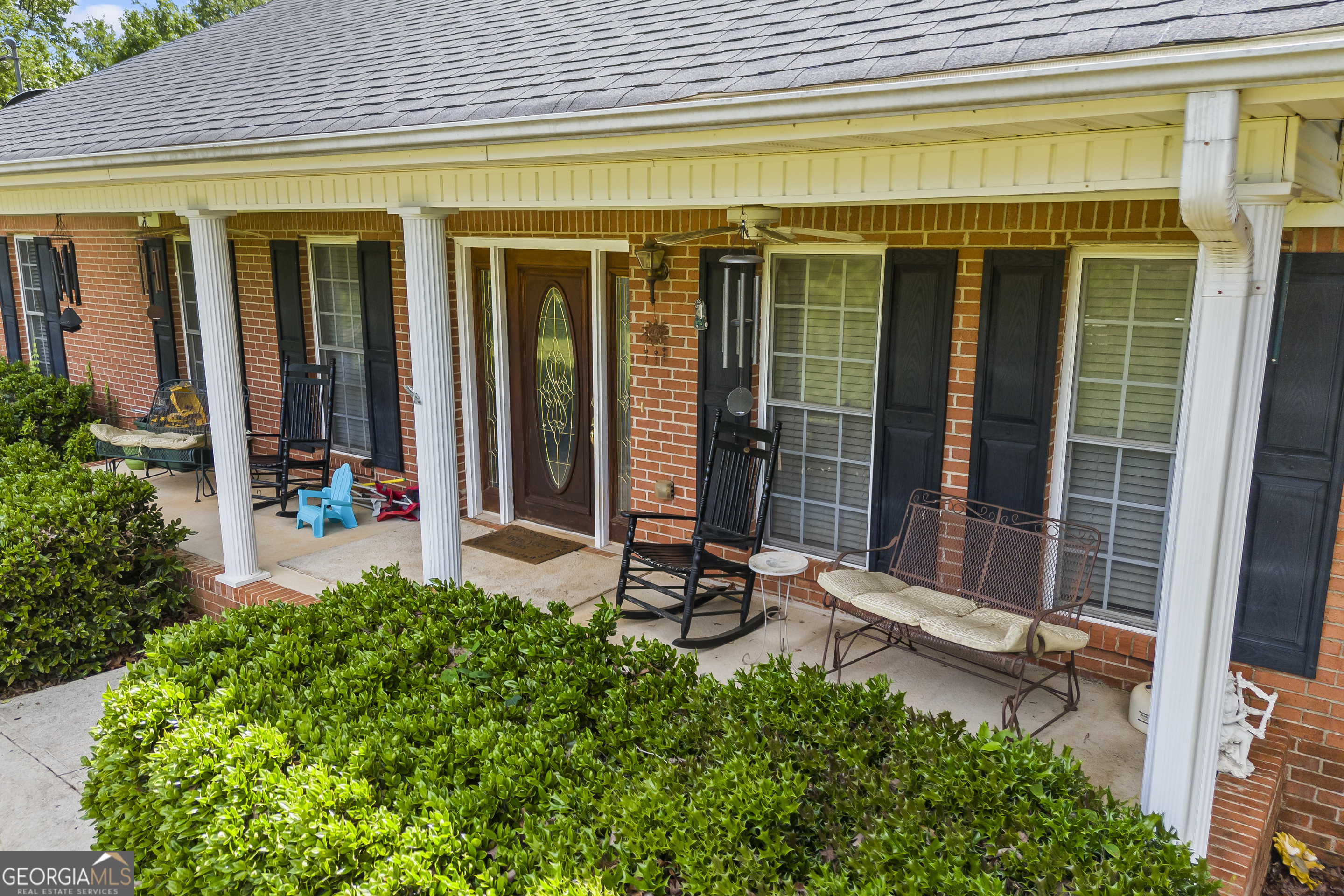 1112 Reno Road Royston, GA 30662 - Photo 14 of 74 a front view of a house with a large window and chair