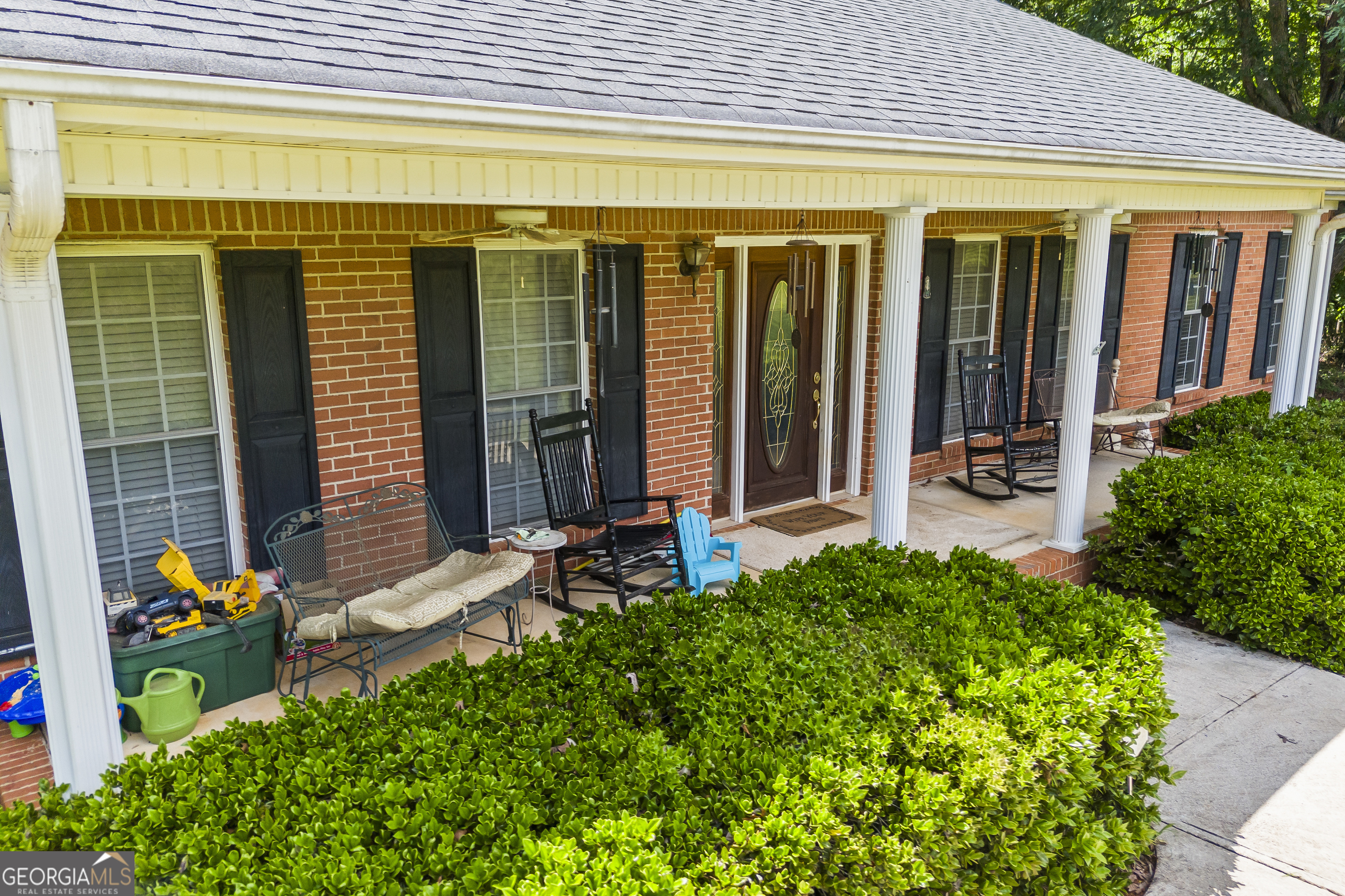 1112 Reno Road Royston, GA 30662 - Photo 15 of 74 a front view of a house with outdoor seating and plants