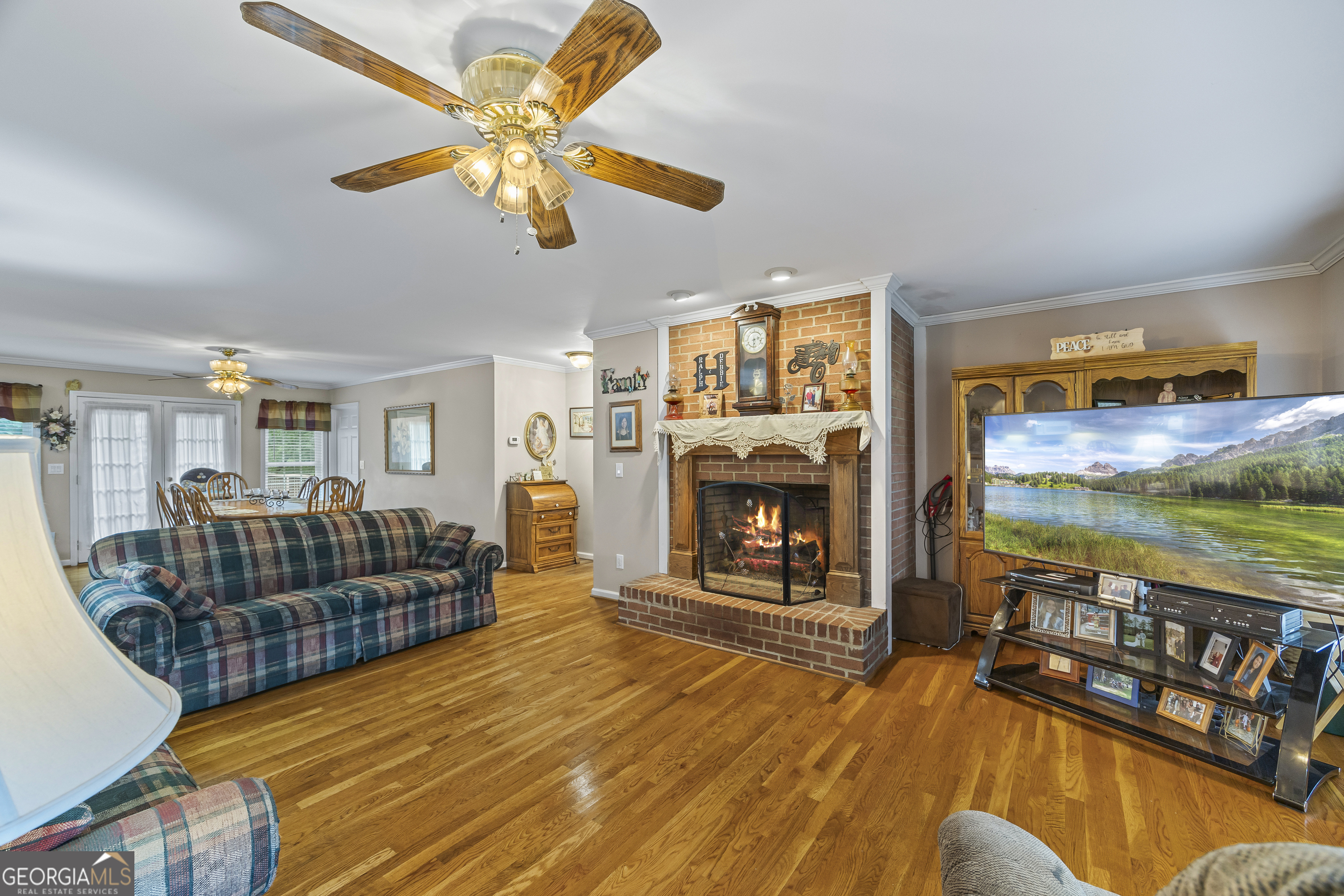 1112 Reno Road Royston, GA 30662 - Photo 30 of 74 a living room with furniture a fireplace and a flat screen tv