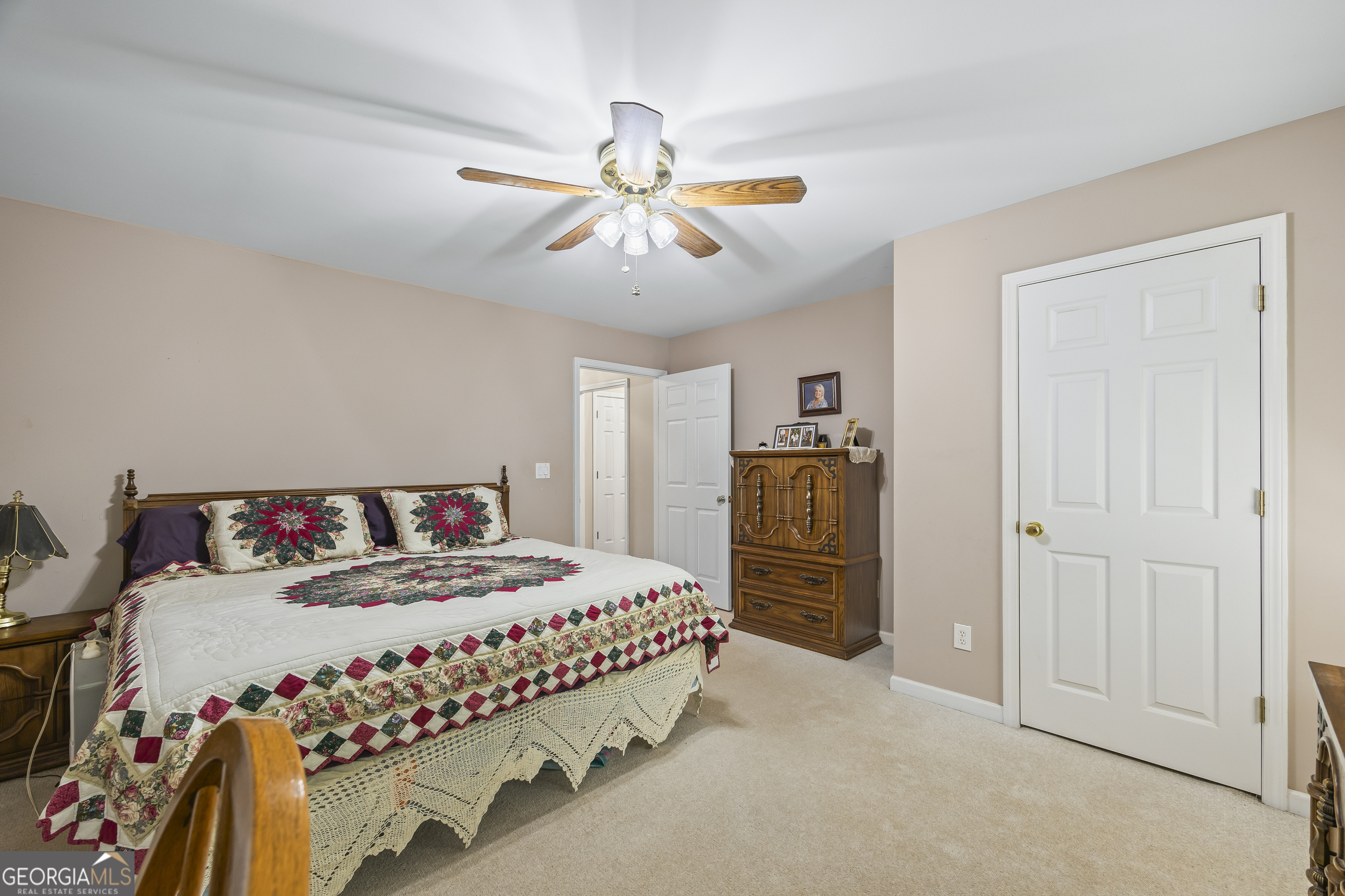 1112 Reno Road Royston, GA 30662 - Photo 53 of 74 a bedroom with a bed and a chandelier