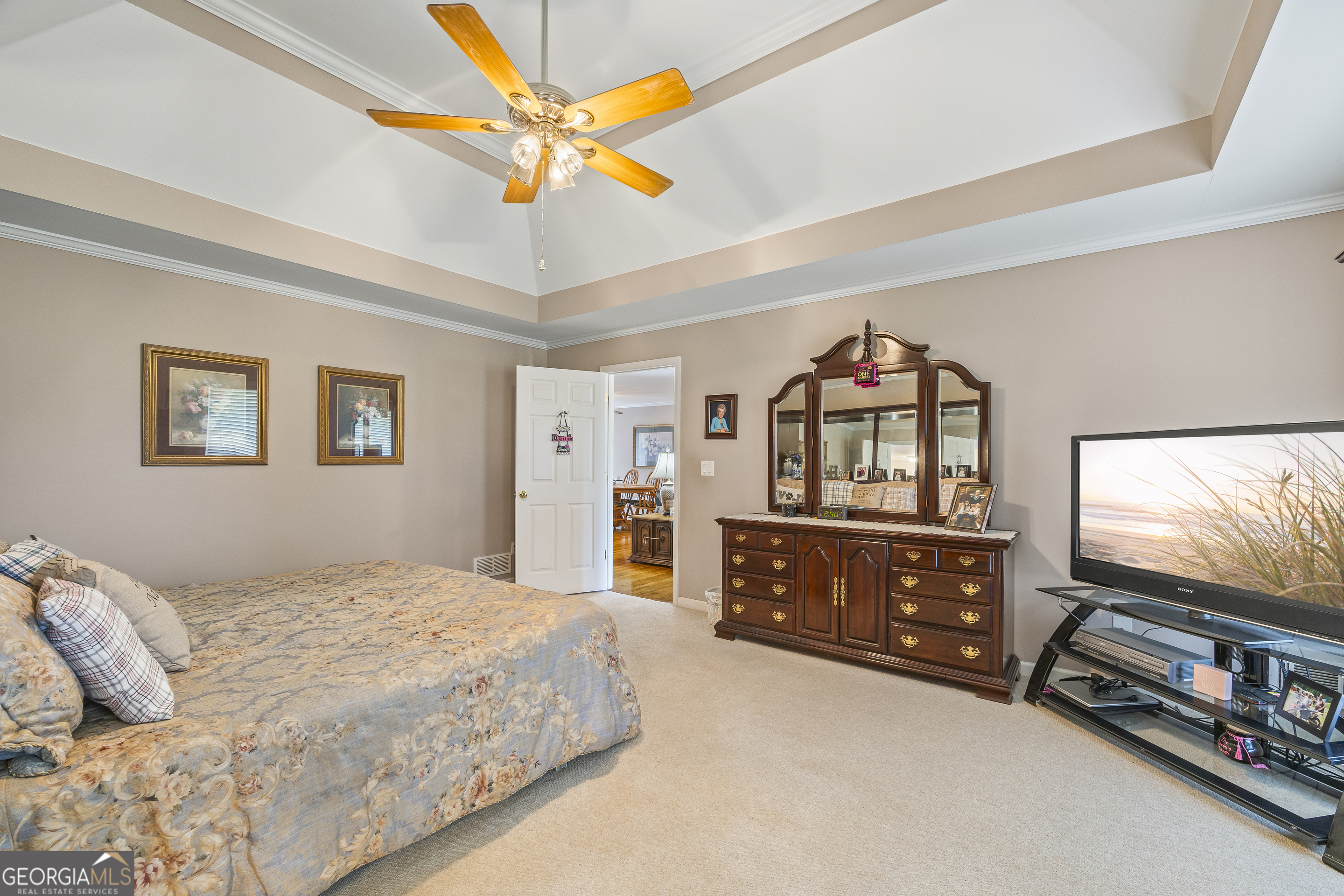 1112 Reno Road Royston, GA 30662 - Photo 59 of 74 a bedroom with a bed dresser and a flat tv screen on dresser