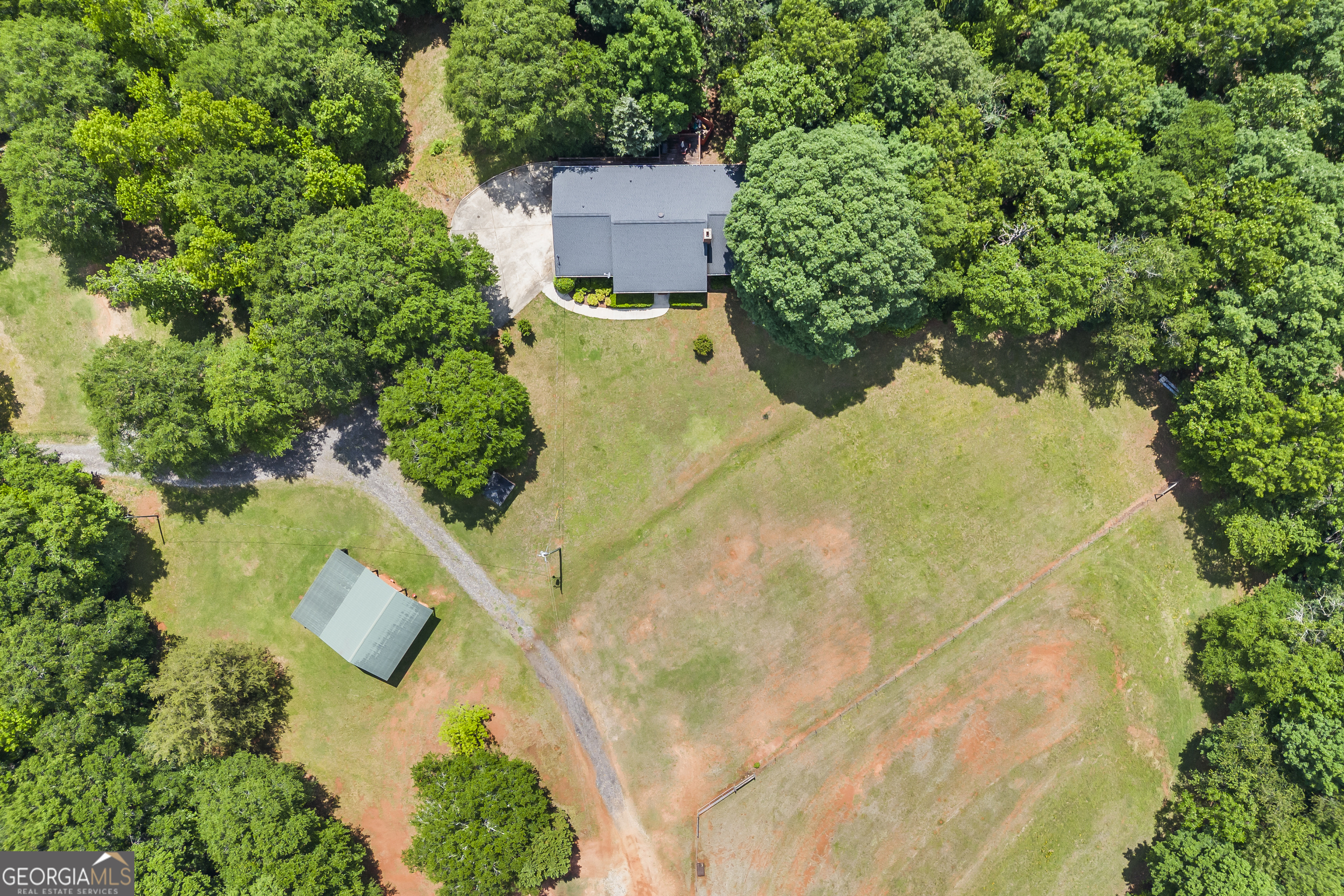 1112 Reno Road Royston, GA 30662 - Photo 9 of 74 an aerial view of residential house with swimming pool and lawn chairs under an umbrella