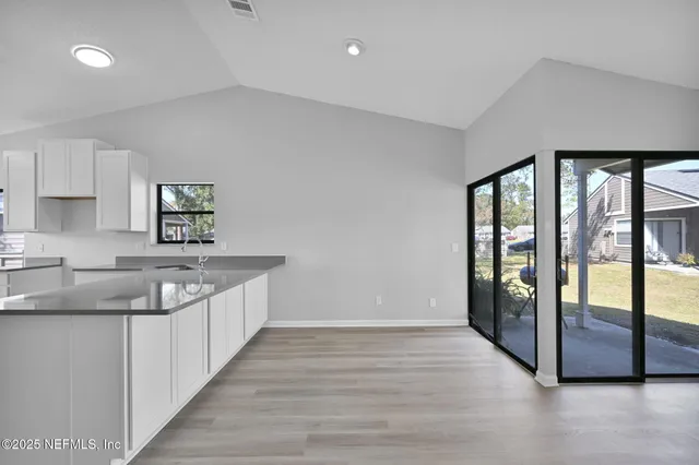 a kitchen with a sink and large window