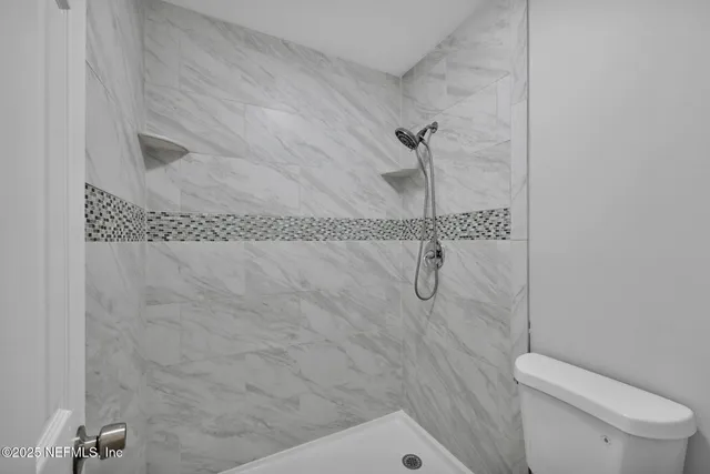 a bathroom with a shower and toilet