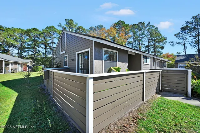 a view of house with backyard