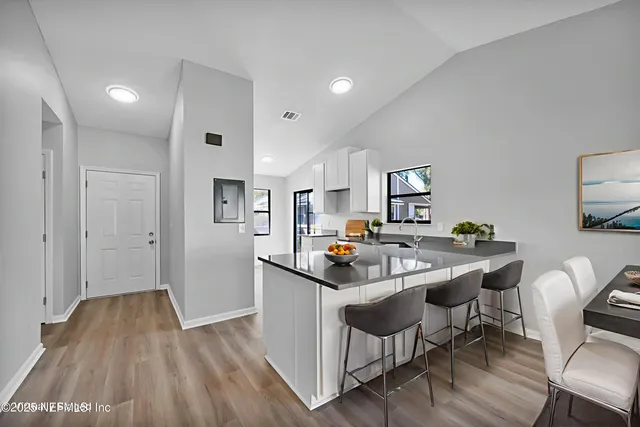 a kitchen with stainless steel appliances granite countertop a sink and a refrigerator