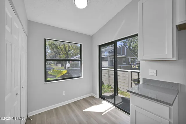 a kitchen with stainless steel appliances granite countertop a stove a sink and a refrigerator with wooden floor