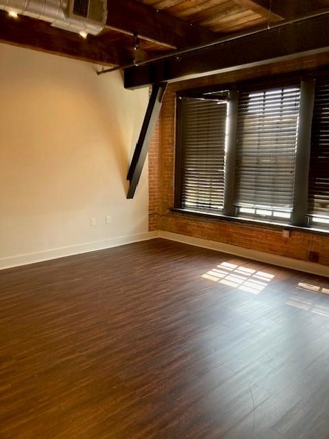 806 Sampson Street, Unit 209 Houston, TX 77003 - Photo 2 of 15 a view of an empty room with wooden floor and a window