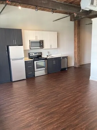 a kitchen with stainless steel appliances a refrigerator and a stove top oven