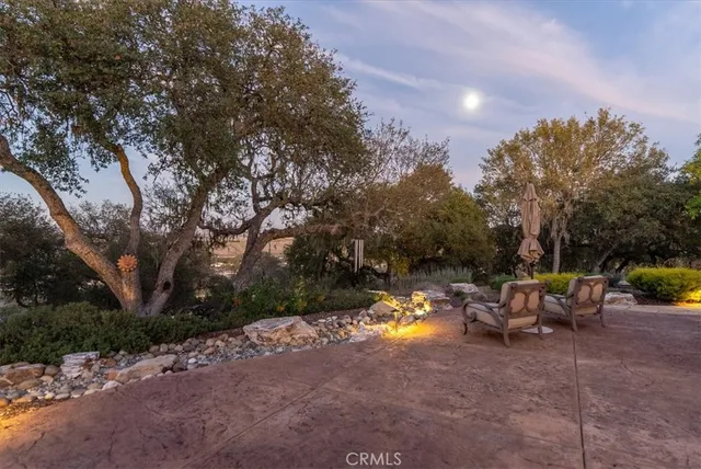 a living room with furniture a window and a chandelier