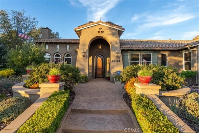 a dining room with furniture water view and large windows