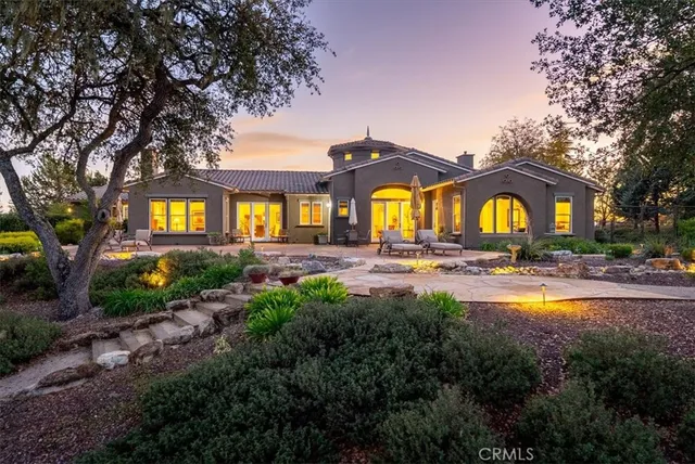 a front view of a house with swimming pool having outdoor seating
