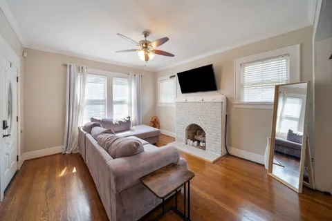 a living room with furniture a fireplace and a flat screen tv