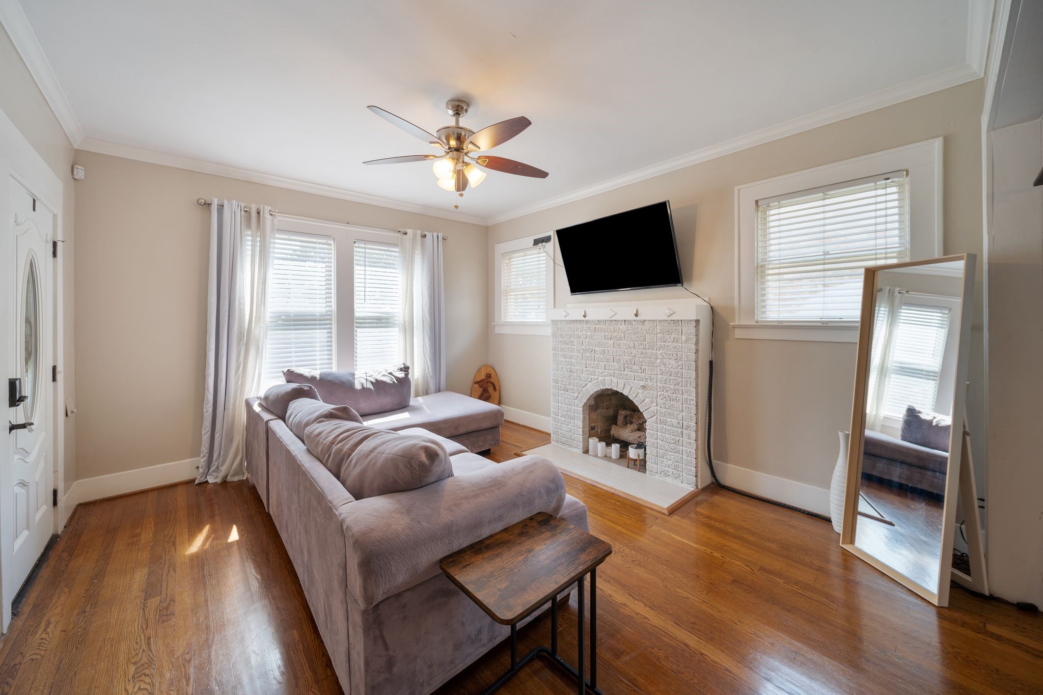 2505 Eagle Street Houston, TX 77004 - Photo 2 of 13 a living room with furniture a fireplace and a flat screen tv