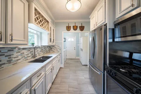 a kitchen with stainless steel appliances granite countertop a refrigerator and a sink