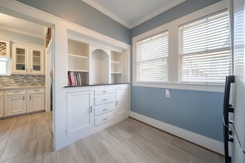 a room with a window and wooden floor