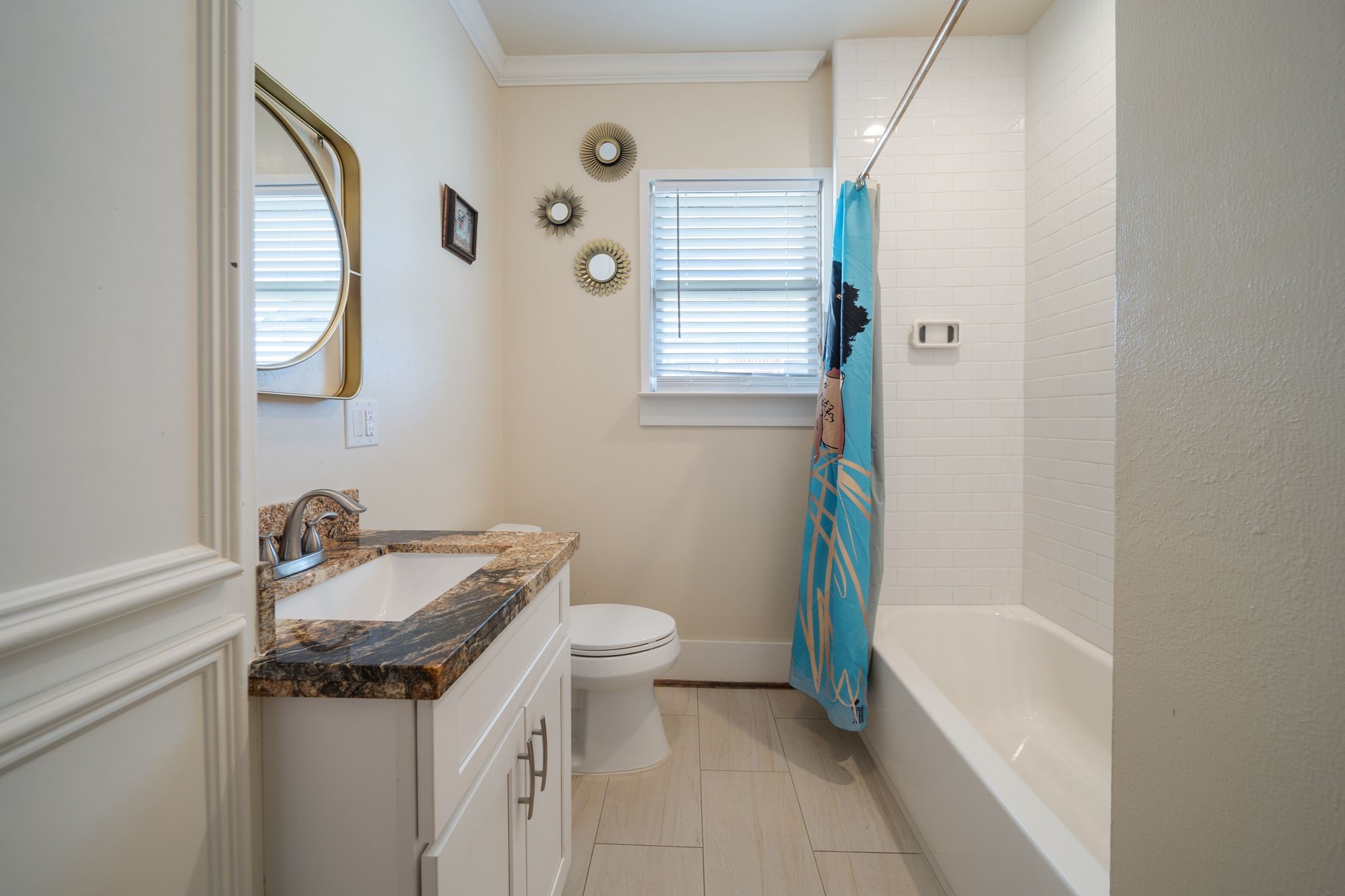 2505 Eagle Street Houston, TX 77004 - Photo 9 of 13 a bathroom with a granite countertop sink a toilet a mirror and bathtub
