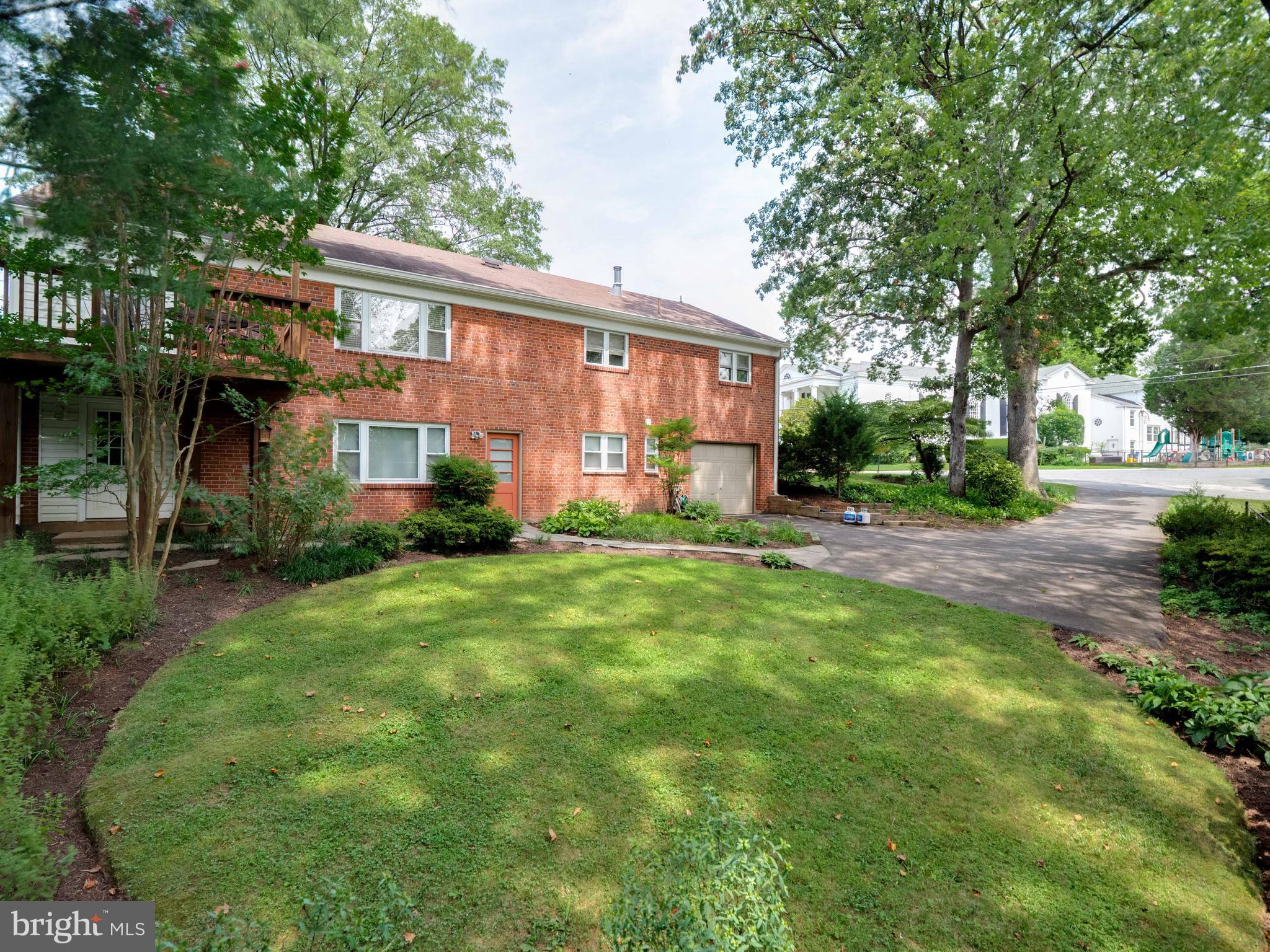 4031 North Glebe Road Arlington, VA 22207 - Photo 22 of 27 a front view of a house with a yard and trees