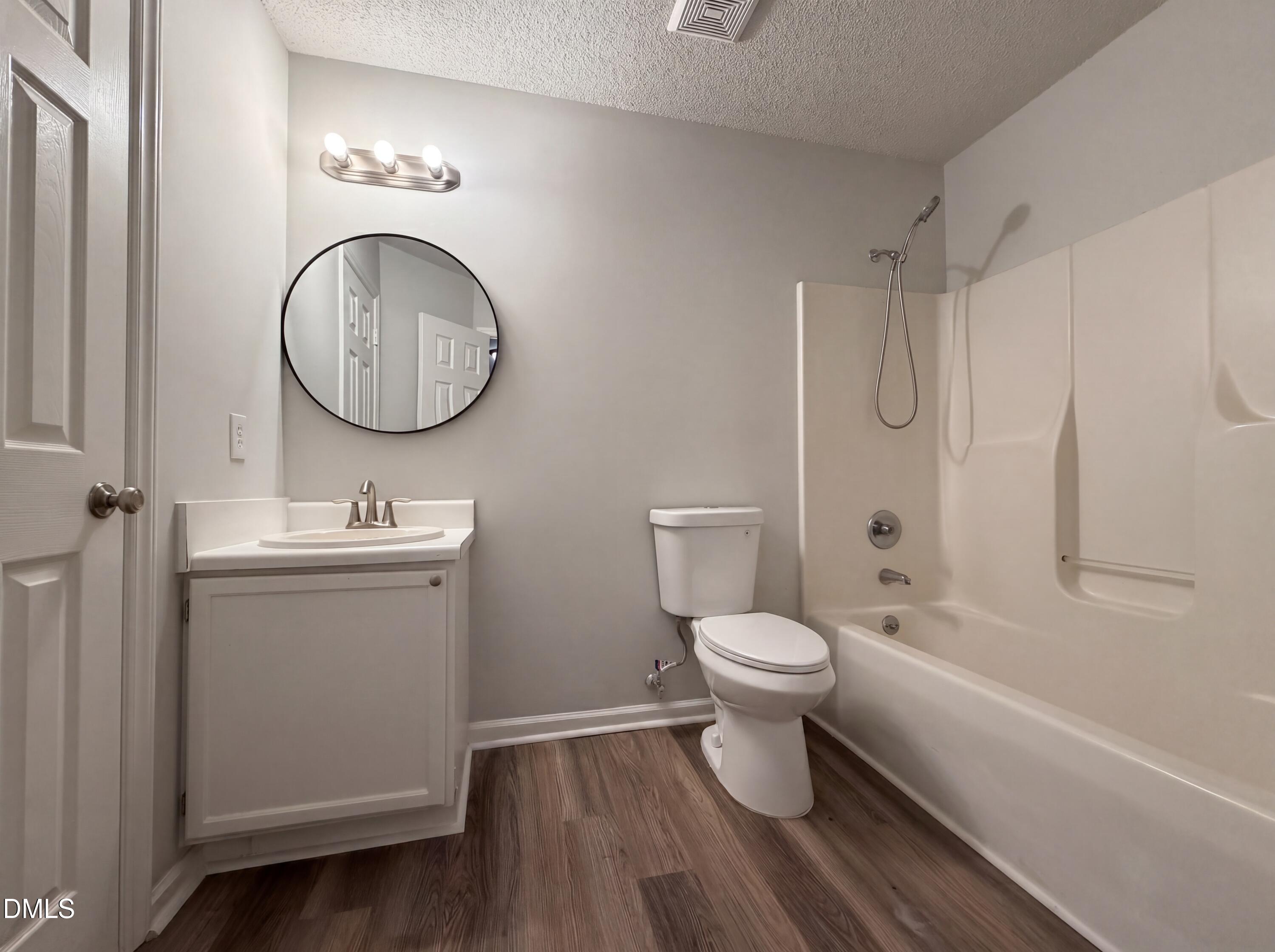 4894 Elevation Road, Unit C Benson, NC 27504 - Photo 15 of 24 a bathroom with a toilet sink and mirror