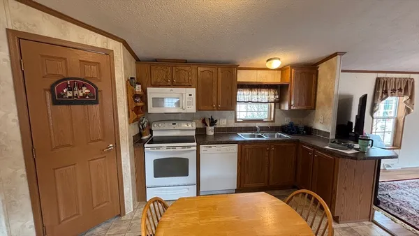 a kitchen with a refrigerator and a stove top oven