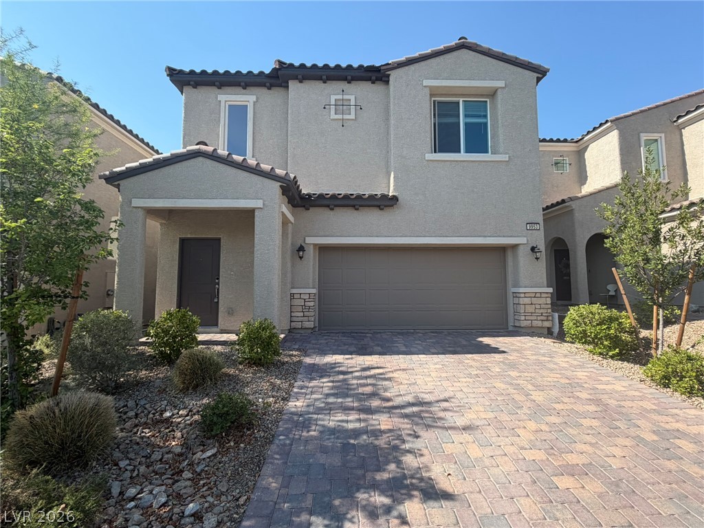 9953 Tucket Point Court Las Vegas, NV 89178 - Photo 1 of 22 A welcoming façade with a paver driveway, an inviting entry, and low-maintenance landscaping.