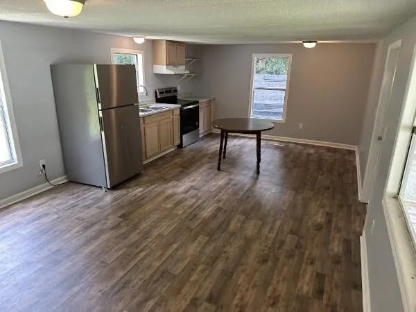 a kitchen with a refrigerator and a table