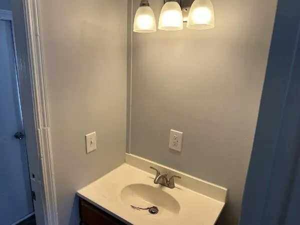 a bathroom with a sink and mirror