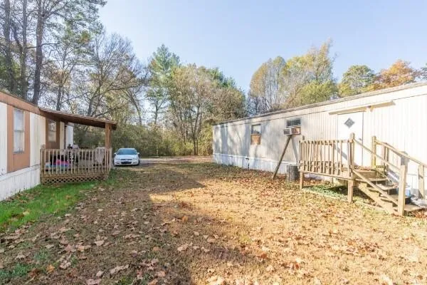 a view of a yard with a house in the background