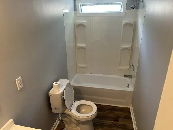 a bathroom with a toilet and a tub